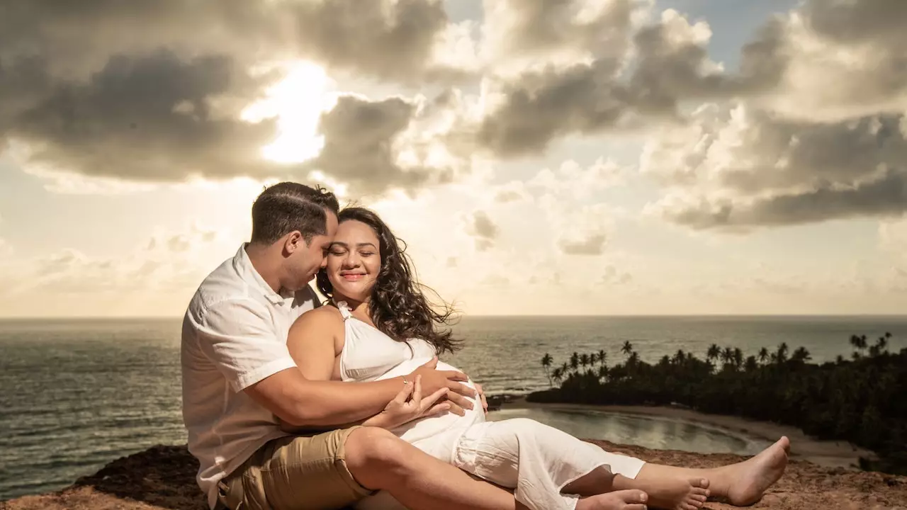 A couple sitting over the coastal cliff edge