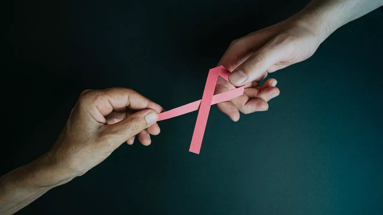 Silhouette of a woman with a pink ribbon, symbolizing breast cancer awareness.