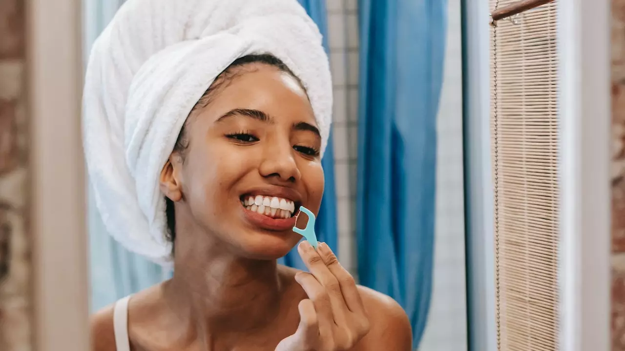Image of a person flossing their teeth with care to improve gum health.