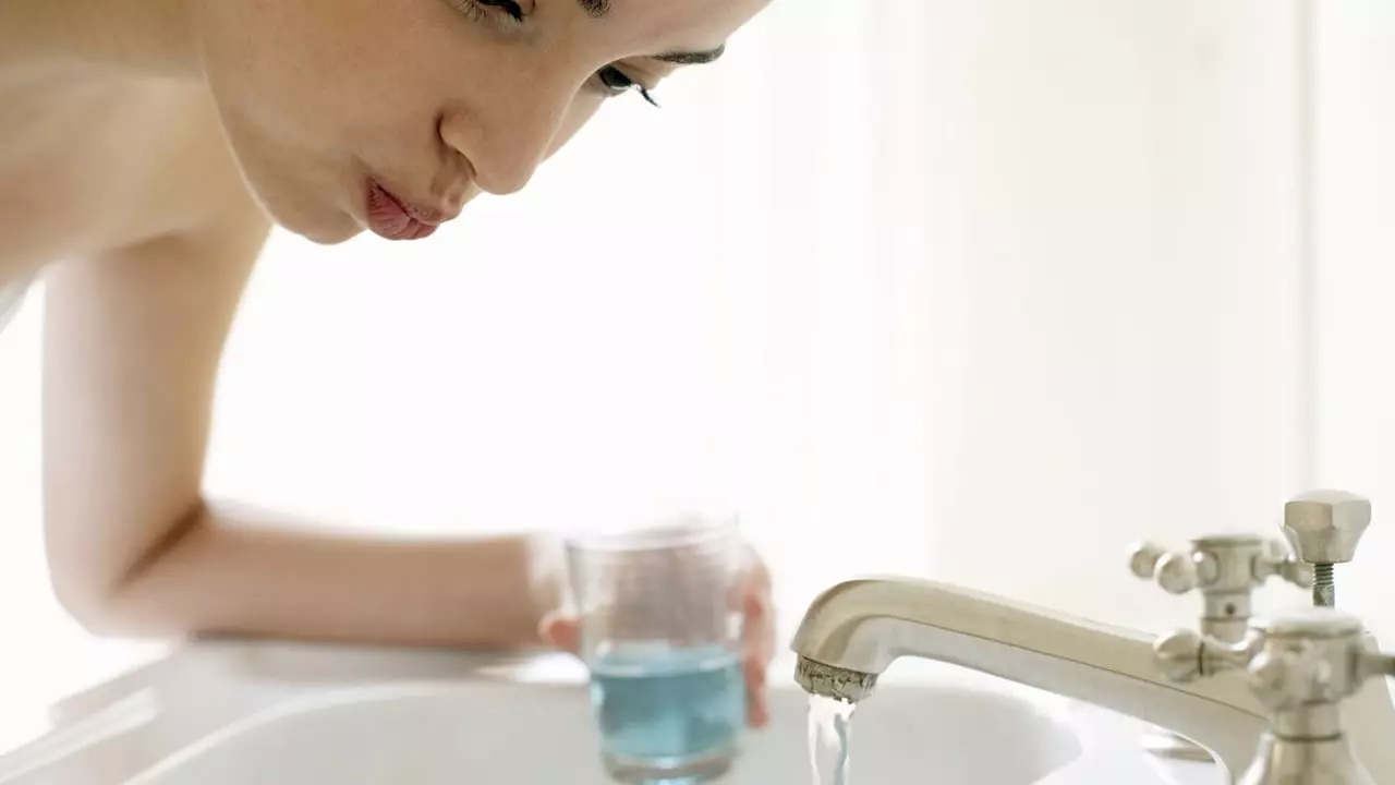 Image of a person rinsing their mouth with mouthwash for added gum protection.