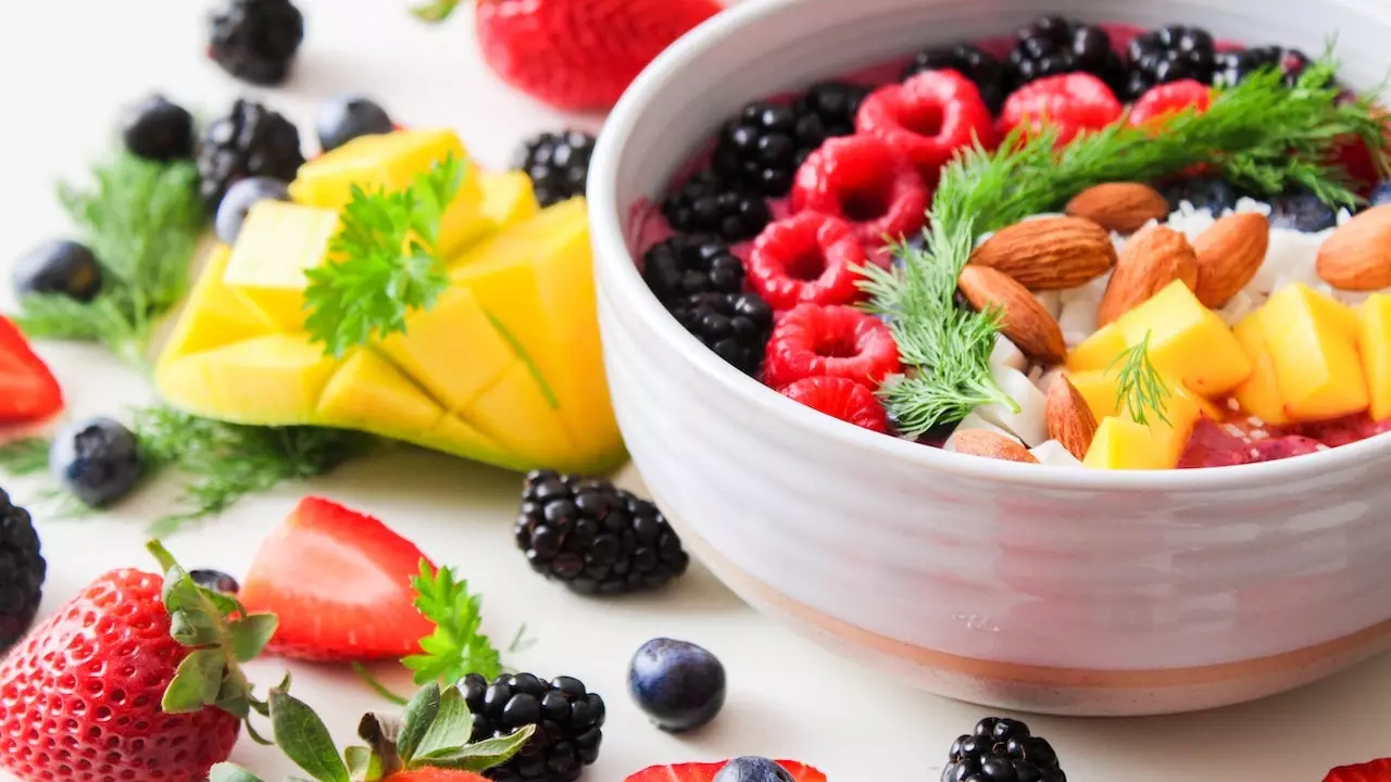 Image of a healthy plate with fruits, vegetables, nuts, and dairy products to promote gum health through nutrition.