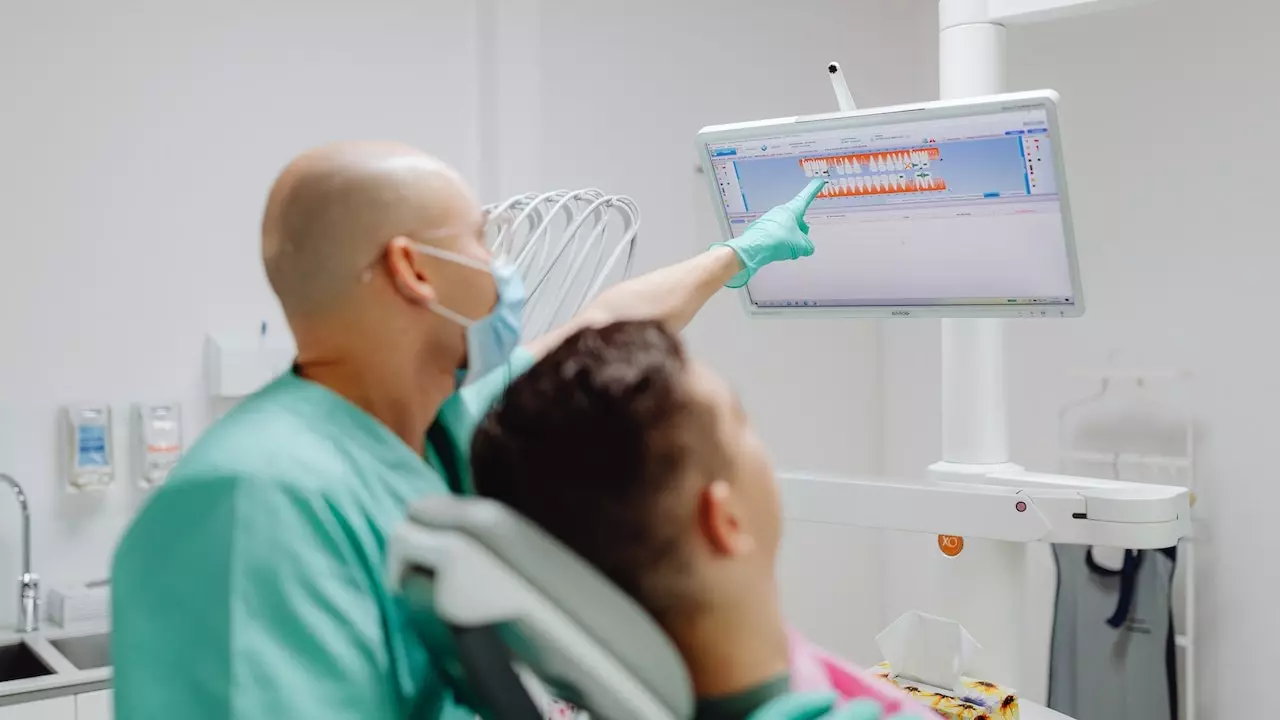 Image of a person having a dental checkup with the dentist to maintain gum health.