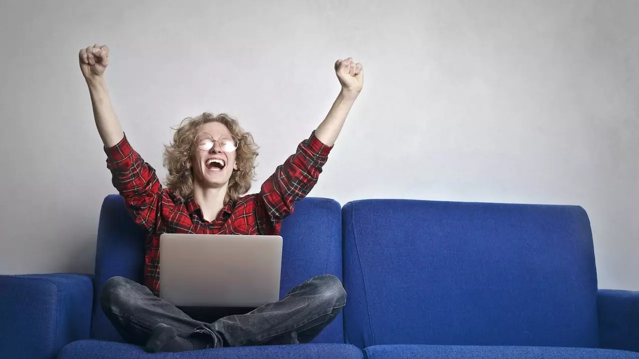 A person using a laptop with various online distractions around, representing the challenges of online procrastination