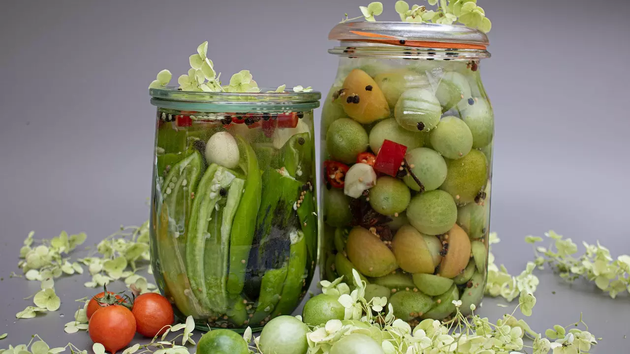 A jar filled with assorted fermented vegetables, showcasing the vibrant colors and textures of the preserved produce.