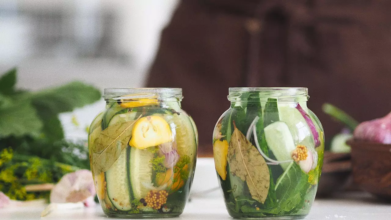 A jar filled with colorful pickled vegetables, highlighting the vibrant hues of the preserved produce.